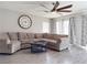 Comfortable living room featuring a ceiling fan, wood-look floors, and many windows at 9509 Arrowhead Falls Ct, Las Vegas, NV 89148