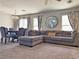 Inviting living room offers a large sectional sofa, elegant dining set, and ample natural light at 9509 Arrowhead Falls Ct, Las Vegas, NV 89148
