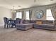 Spacious living room features a comfortable sectional sofa, dining area, and decorative mirror at 9509 Arrowhead Falls Ct, Las Vegas, NV 89148