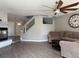 The Living Room features wood floors, fan, and access to stairway and entry at 9509 Arrowhead Falls Ct, Las Vegas, NV 89148
