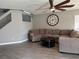The living room features wood floors, fan, and access to stairway and entry at 9509 Arrowhead Falls Ct, Las Vegas, NV 89148