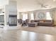 Bright living room shows fireplace, dining area, natural light, and comfortable sectional seating at 9509 Arrowhead Falls Ct, Las Vegas, NV 89148
