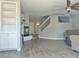 Bright living room with fireplace, ceiling fan, staircase with glass panels and wood-look floors at 9509 Arrowhead Falls Ct, Las Vegas, NV 89148