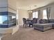Cozy living room boasts a modern fireplace, dining area, and neutral color palette at 9509 Arrowhead Falls Ct, Las Vegas, NV 89148