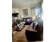Inviting living room with a comfortable brown leather sofa set, hardwood floors, and streaming sunlight at , Las Vegas, NV 89118