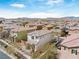 Aerial view of a neighborhood with tile roofs under a bright blue sky with mountain views at 10943 Ketchikan St, Las Vegas, NV 89179