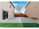 Backyard featuring brick pavers and synthetic grass at 10943 Ketchikan St, Las Vegas, NV 89179