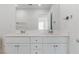 Bright bathroom featuring dual sinks with chrome fixtures, and a large frameless mirror at 10943 Ketchikan St, Las Vegas, NV 89179