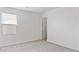 Bright bedroom featuring neutral carpet, window, and white trim, offers a tranquil retreat at 10943 Ketchikan St, Las Vegas, NV 89179