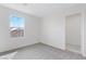 Bright bedroom featuring neutral carpet, window, and white trim, offers a tranquil retreat at 10943 Ketchikan St, Las Vegas, NV 89179