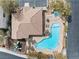 Aerial view of a community pool, hot tub, bbq area, playground, and lounge chairs at 10943 Ketchikan St, Las Vegas, NV 89179
