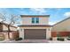 Two-story home with attached garage, desert landscaping, and brick surround at 10943 Ketchikan St, Las Vegas, NV 89179