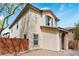 Charming two-story home featuring tan stucco, a tile roof, and tasteful blue shutters at 10943 Ketchikan St, Las Vegas, NV 89179