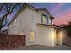 Charming two-story home with stucco exterior, tile roof, and beautiful blue shutters under a dusk sky at 10943 Ketchikan St, Las Vegas, NV 89179