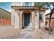 Inviting front entrance with a decorative archway, well-lit by sconces, with desert landscaping and a brick paver path at 10943 Ketchikan St, Las Vegas, NV 89179