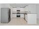 Modern kitchen with stainless steel appliances, white cabinets, and granite countertops at 10943 Ketchikan St, Las Vegas, NV 89179