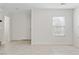 Open-concept living space with tile floors, windows, and a view into another room at 10943 Ketchikan St, Las Vegas, NV 89179