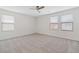 Spacious main bedroom with carpet floors, ceiling fan and plenty of natural light from the windows at 10943 Ketchikan St, Las Vegas, NV 89179