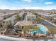 Community pool and playground, with lounge chairs, mature trees, lush landscaping, and mountain views at 10943 Ketchikan St, Las Vegas, NV 89179