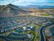 This aerial view displays a vibrant community with mountain views, showcasing its residential and recreational amenities at 11137 Black Fire Opal Dr, Las Vegas, NV 89138