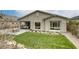 This backyard features artificial grass and a patio area with a fire pit, creating an inviting outdoor space at 11137 Black Fire Opal Dr, Las Vegas, NV 89138