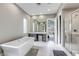 Modern bathroom showcasing a standalone tub, walk-in shower, vanity, and access to the bedroom at 11137 Black Fire Opal Dr, Las Vegas, NV 89138