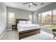Serene bedroom with a large window, soft carpet, a ceiling fan, and a comfortable bed at 11137 Black Fire Opal Dr, Las Vegas, NV 89138