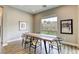 Inviting dining area with a wooden table, modern chairs, and a large window offering natural light at 11137 Black Fire Opal Dr, Las Vegas, NV 89138