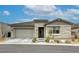 Charming single-story home featuring a gray stone facade, two car garage, and well-maintained landscaping at 11137 Black Fire Opal Dr, Las Vegas, NV 89138