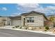 Charming single-story home boasts a manicured front yard, stone accents, and a neutral color palette at 11137 Black Fire Opal Dr, Las Vegas, NV 89138