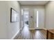 Hallway with wood floors and artwork, offering a glimpse into another room at 11137 Black Fire Opal Dr, Las Vegas, NV 89138