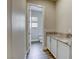 Hallway showing white cabinets with granite countertop and a half bathroom with a view of the toilet at 11137 Black Fire Opal Dr, Las Vegas, NV 89138