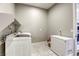 The laundry room features a white washer, dryer, freezer, tile flooring and neutral paint for a clean, functional space at 11137 Black Fire Opal Dr, Las Vegas, NV 89138