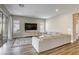 Cozy living room with modern decor, sliding glass doors to patio, wood flooring and a comfortable sofa at 11137 Black Fire Opal Dr, Las Vegas, NV 89138