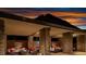This covered outdoor lounge offers comfortable seating and stone pillars, with views of the mountains and sunset at 11137 Black Fire Opal Dr, Las Vegas, NV 89138