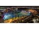 Night aerial view of illuminated Topgolf range with city lights in background at 125 E Harmon Ave # 2220, Las Vegas, NV 89109