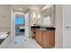 Bathroom with wood vanity, black countertop, decorative mirror and access to another room with a view at 125 E Harmon Ave # 2220, Las Vegas, NV 89109