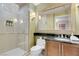 Well lit bathroom featuring a walk-in shower and black marble countertop at 125 E Harmon Ave # 2220, Las Vegas, NV 89109