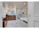 This bathroom features a soaking tub, glass enclosed shower, and wooden vanity with a marble countertop at 125 E Harmon Ave # 2220, Las Vegas, NV 89109