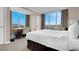 Bright bedroom features floor-to-ceiling windows, desk, and neutral color palette at 125 E Harmon Ave # 2220, Las Vegas, NV 89109