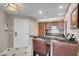 Kitchen featuring wood cabinetry, stainless steel appliances, and a counter with seating at 125 E Harmon Ave # 2220, Las Vegas, NV 89109