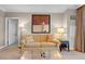 Comfortable living room featuring a stylish sofa, artwork, and a side table at 125 E Harmon Ave # 2220, Las Vegas, NV 89109