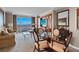 Living room with comfortable seating, large windows with expansive views and entertainment center at 125 E Harmon Ave # 2220, Las Vegas, NV 89109