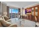 Living room with comfortable seating, large windows offering expansive city views, and entertainment center at 125 E Harmon Ave # 2220, Las Vegas, NV 89109
