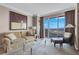 Living room with comfortable seating, large windows offering expansive city views, and modern artwork at 125 E Harmon Ave # 2220, Las Vegas, NV 89109