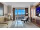 Living room with comfortable seating, large windows offering expansive city views, and entertainment center at 125 E Harmon Ave # 2220, Las Vegas, NV 89109