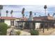 Casa Vegas building with a red tile roof, lush greenery, mature trees and a welcoming entryway at 1405 Vegas Valley Dr # 114, Las Vegas, NV 89169