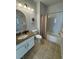A well-lit bathroom features granite countertops, tile flooring, and a shower-tub combo at 1725 Queen Victoria St # 103, Las Vegas, NV 89144