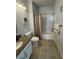 A well-lit bathroom features granite countertops, tile flooring, and a shower-tub combo at 1725 Queen Victoria St # 103, Las Vegas, NV 89144