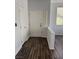 Bright foyer featuring wood-look flooring, white walls, and natural light from window at 1725 Queen Victoria St # 103, Las Vegas, NV 89144